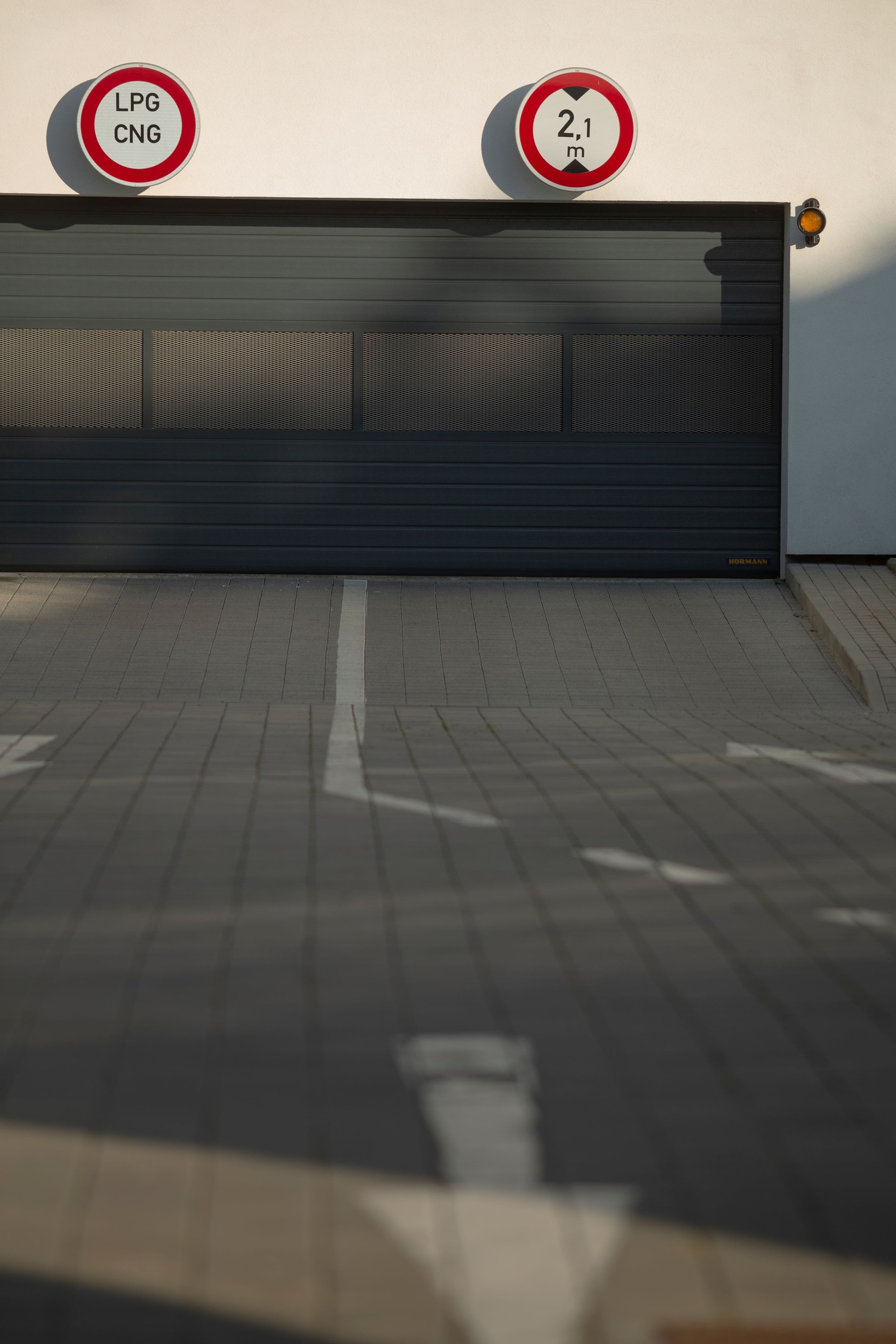 A parking garage features a prominent sign displaying the word UPS on it